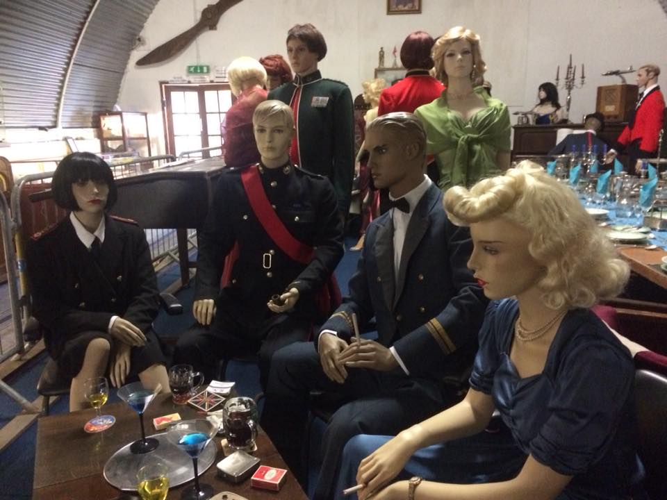 Mannequins dressed in wartime garb are on exhibition at the Cornwall at War Museum near Cornwall village Tintagel. A blond-haired model has a table in front of her with some drinks on and there are other service men and women around the table with yet others standing at the back. This is one of many museum exhibits at the tourist attraction near Launceston