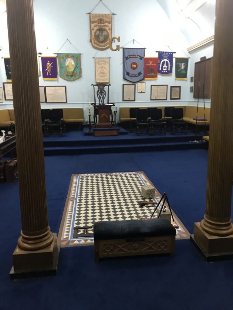 The interior of the Redruth Masonic Hall is slightly dark here but shows the grand floor and symbols