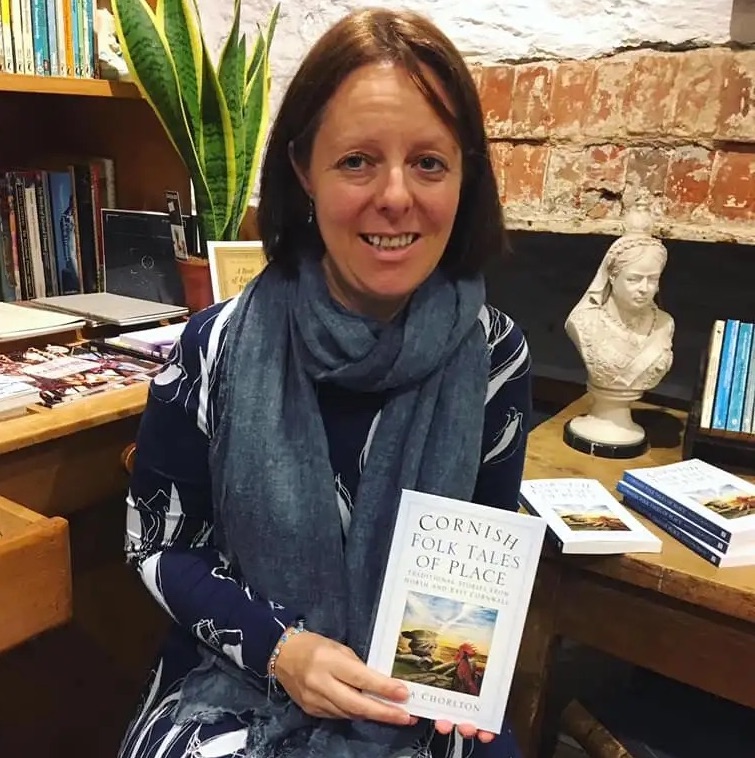Cornwall author Anna Chorlton holds her 2019 book 'Cornish Folk Tales of Place' as she sits in her office next to a bust of Queen Victoria. Chorlton is quoted in Lawrence McNeela's article on Cornish folklore and its renaissance in the modern day, published on the Proper Cornwall website in 2024